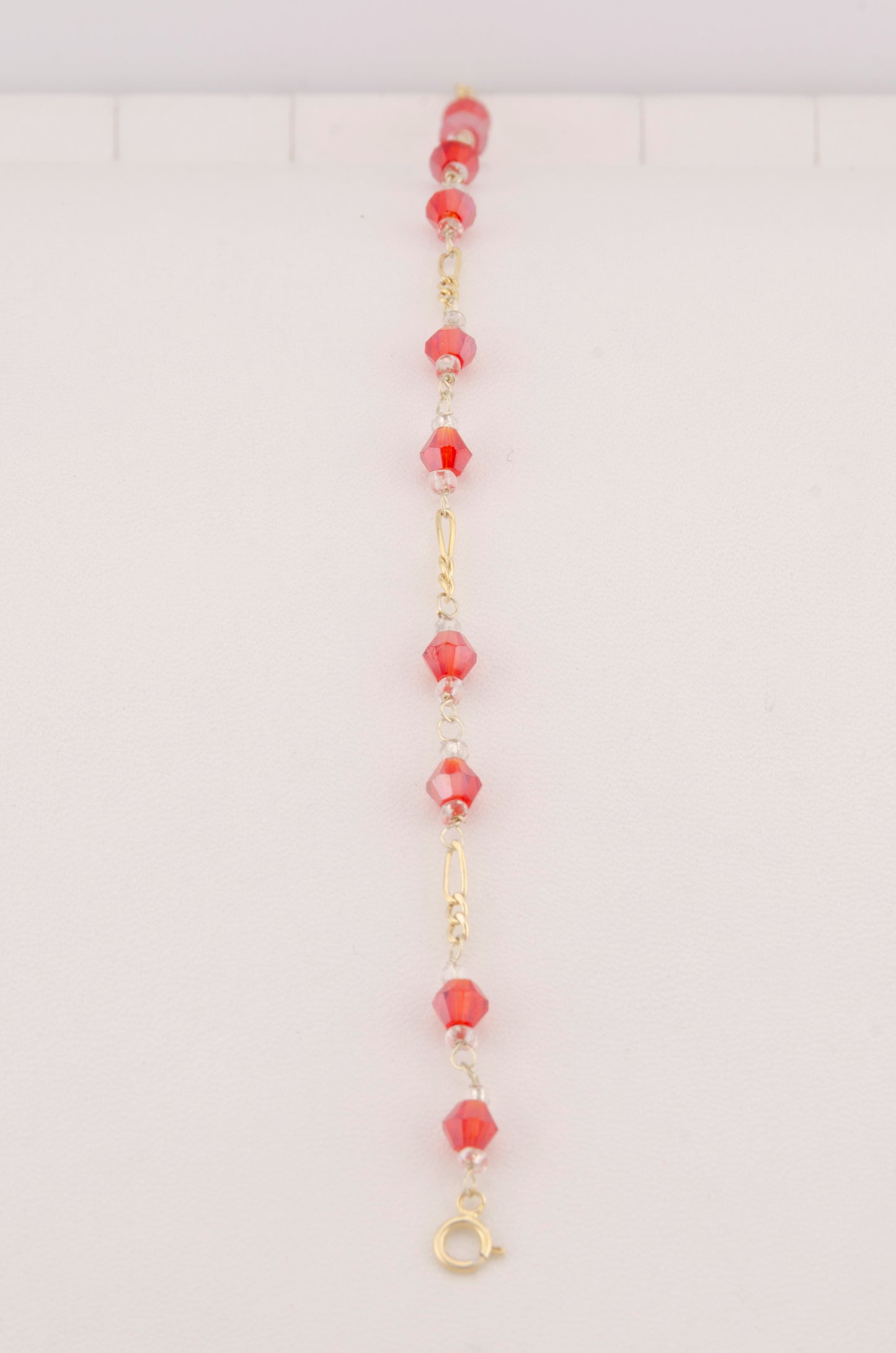 "PULSERA CRISTALES SWAROSKY ROJOS. ORO 10K #775-3336"